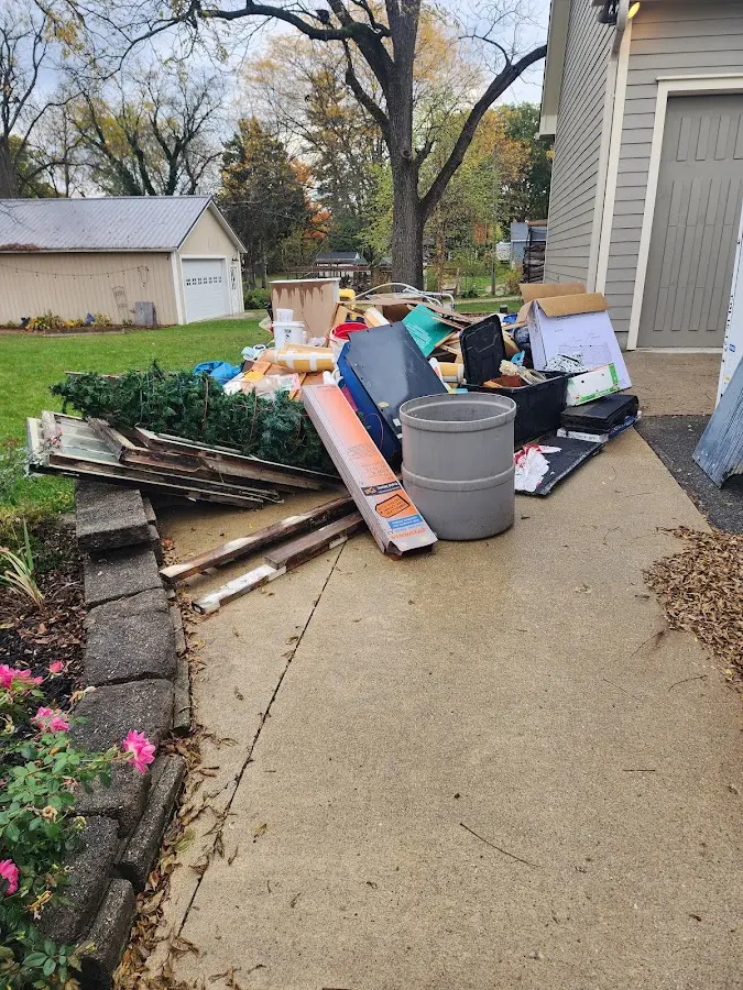 Dumpster being loaded with debris for Estate Cleanout Dumpster Rental in Kendallville